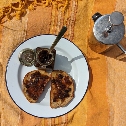 Barabrith and best spiced rum marmalade made with Barti Spiced Rum. top view of open jar with marmalade spread on toast