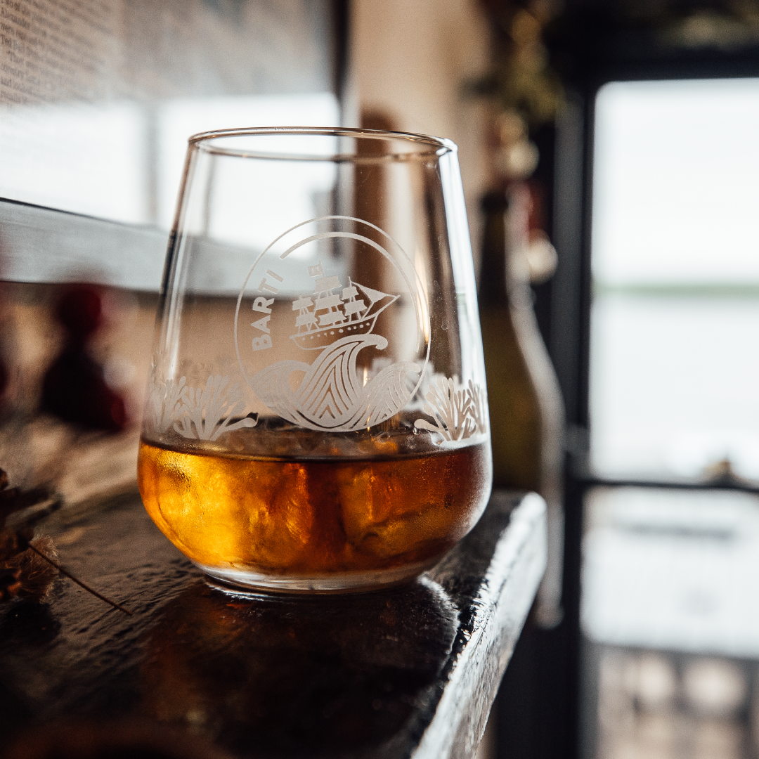 Best Spiced Rum Drinking Glass on a bar with Best Spiced Rum inside