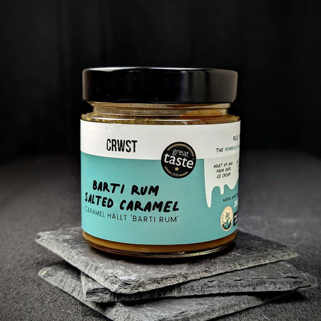 Crwst Award Winning Salted Caramel made with the best spiced rum from Barti Spiced Rum. On slate coasters