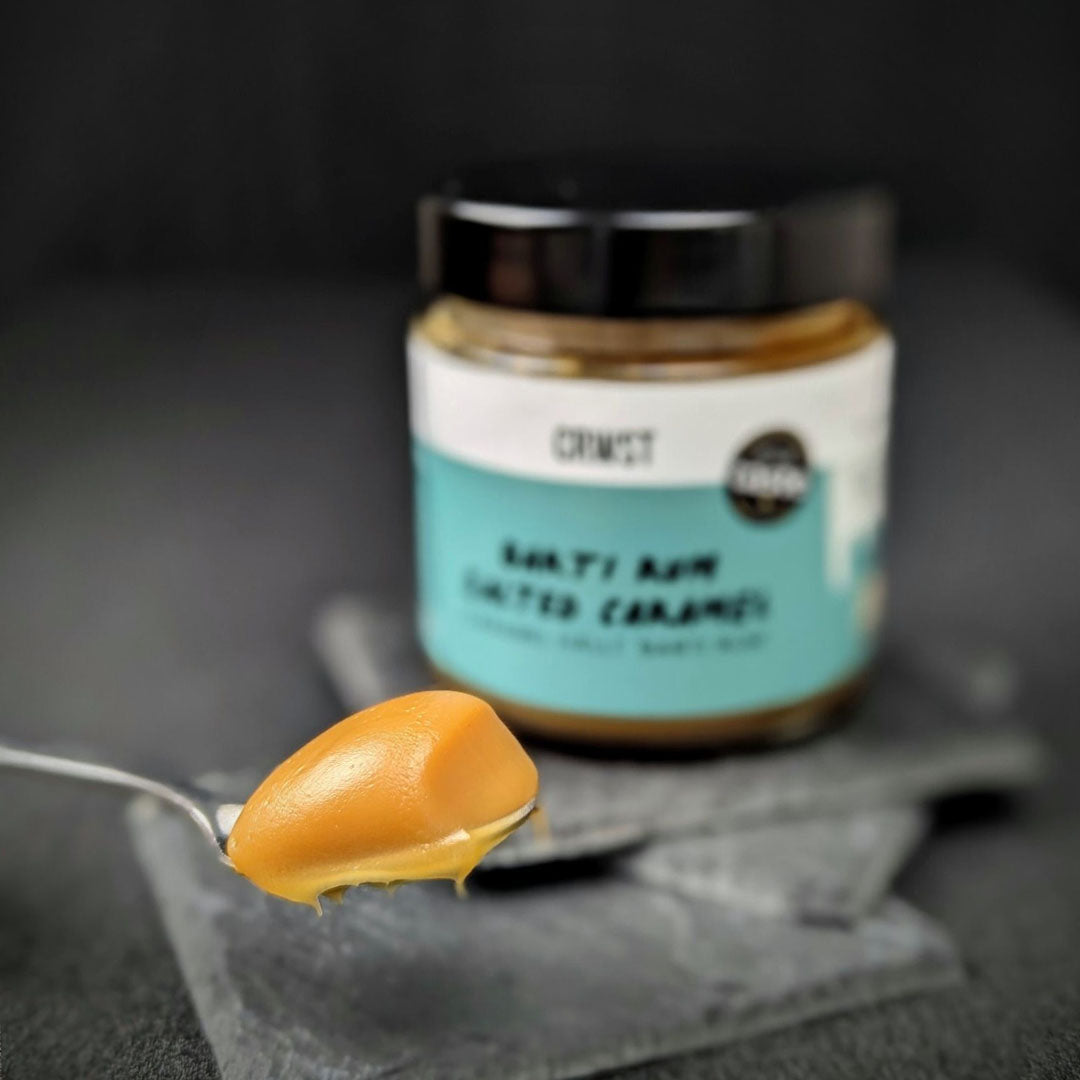 Crwst Award Winning Salted Caramel made with the best spiced rum from Barti Spiced Rum. showing salted caramel on a spoon