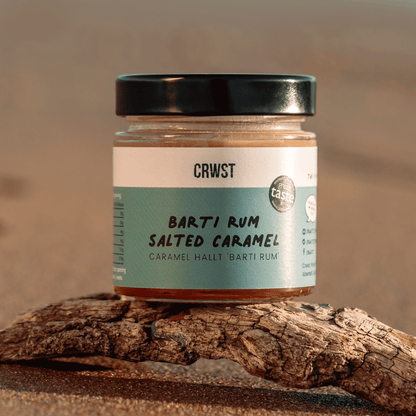 Crwst Award Winning Salted Caramel made with the best spiced rum from Barti Spiced Rum. On drift wood