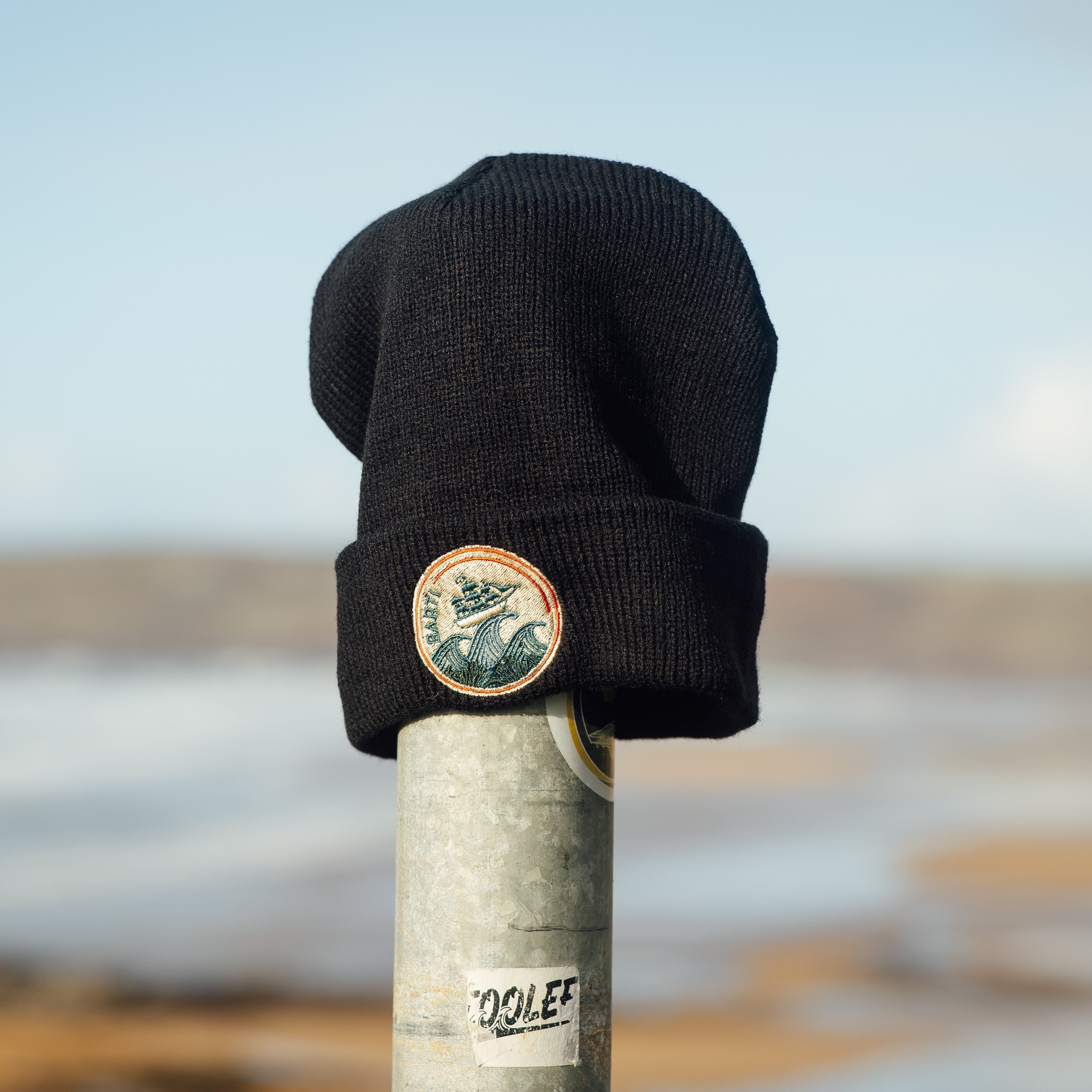 Knitted beanie hat in black with embroidered Barti Rum logo